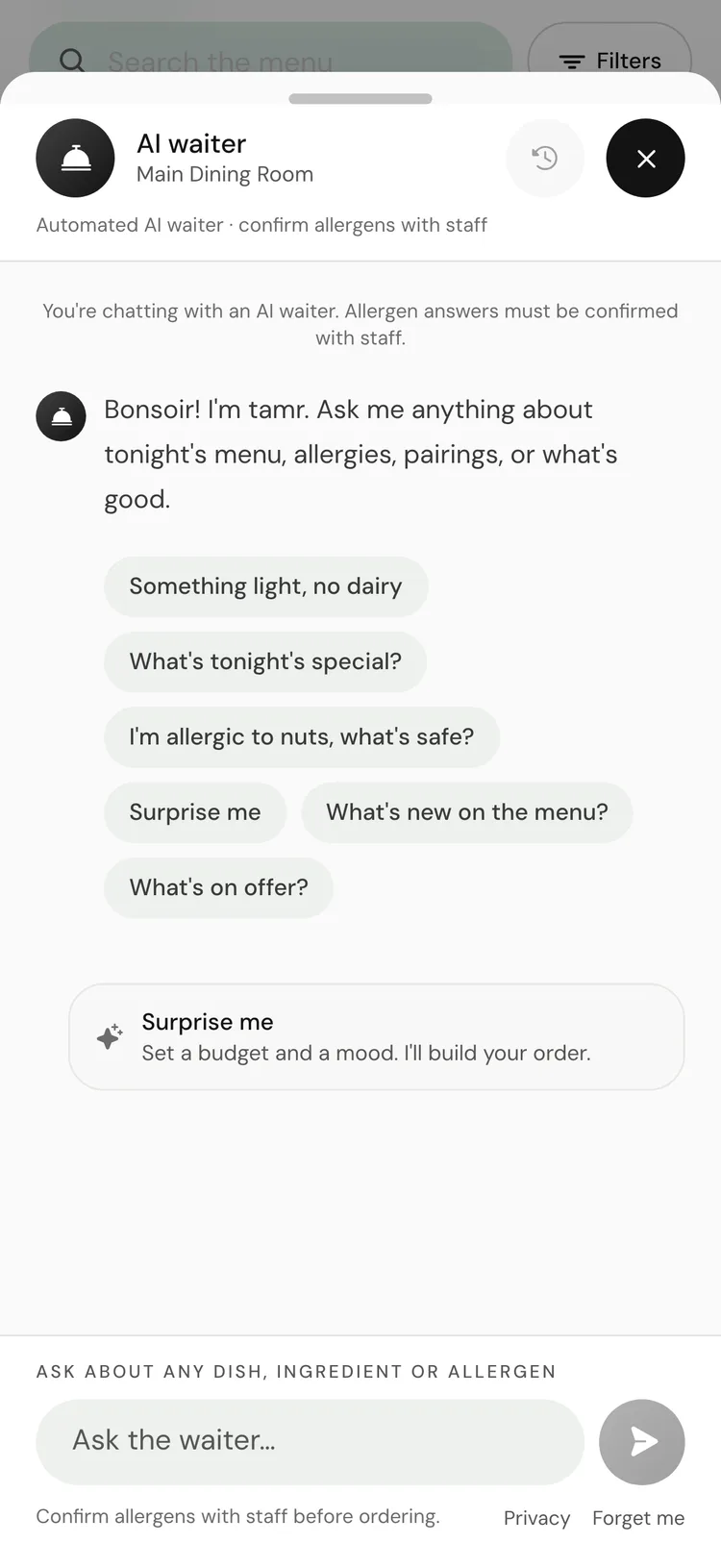The AI waiter chat open on a phone, with the greeting, tappable starter questions, and the message box